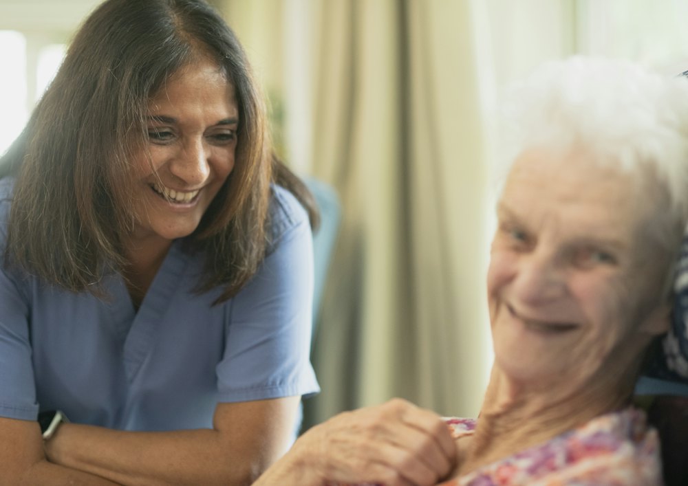 A nurse smiling with an older resident